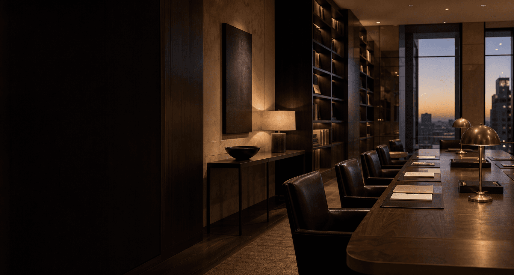 A quiet contemporary legal library at dusk with a conference table and city view
