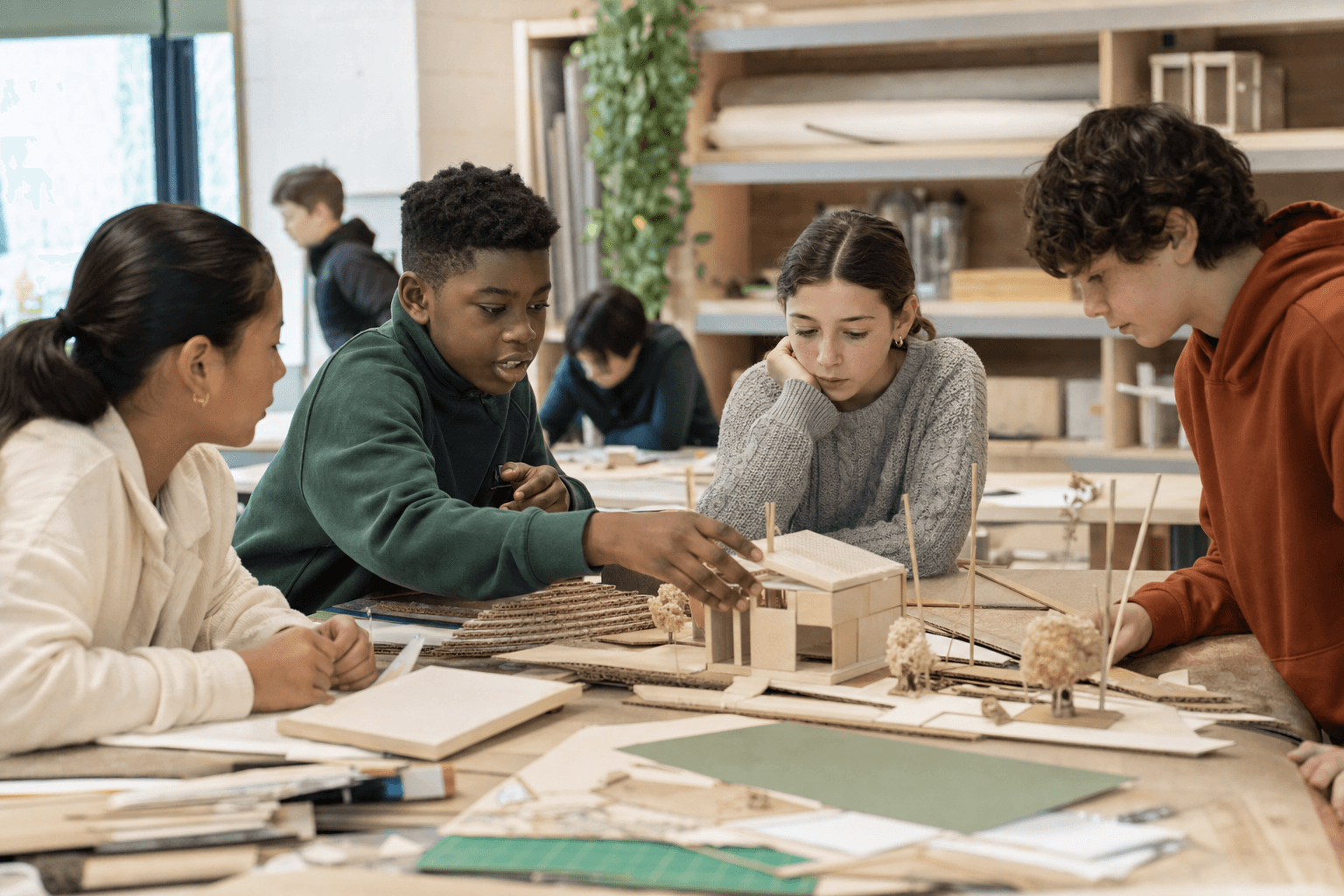 Students building and discussing a model together in the design studio